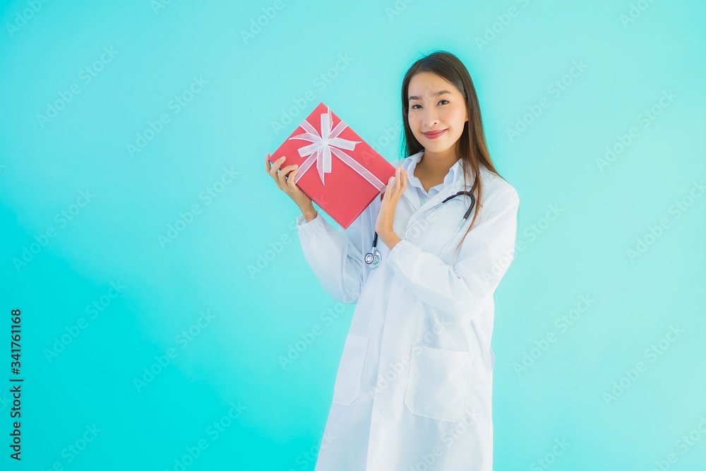 Portrait beautiful young asian doctor woman with gift box Portrait beautiful young asian doctor woman with gift box