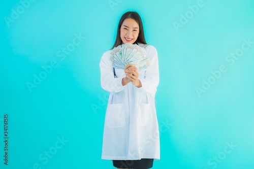 Portrait beautiful young asian doctor woman with a lot of cash and money