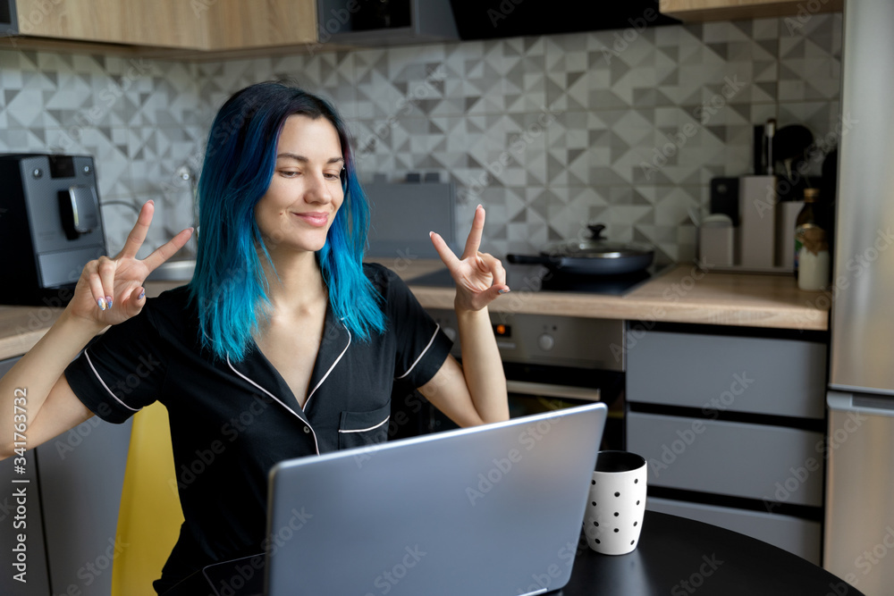Beautiful young hipster woman talk online call friends at modern kitchen Beautiful young hipster woman talk online call friends at modern kitchen