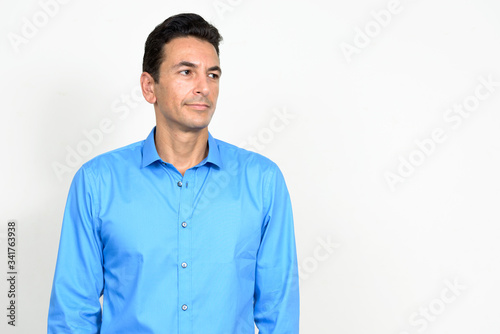 Portrait of mature handsome businessman thinking and looking away © Ranta Images