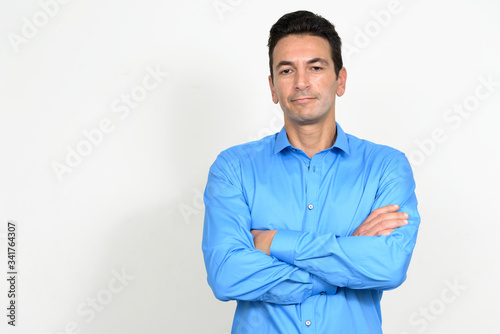 Portrait of mature handsome businessman with arms crossed © Ranta Images