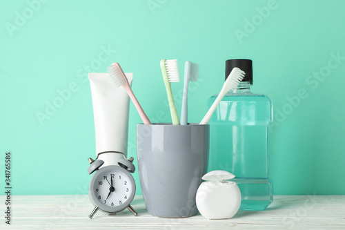 Tools for dental care on mint background, close up