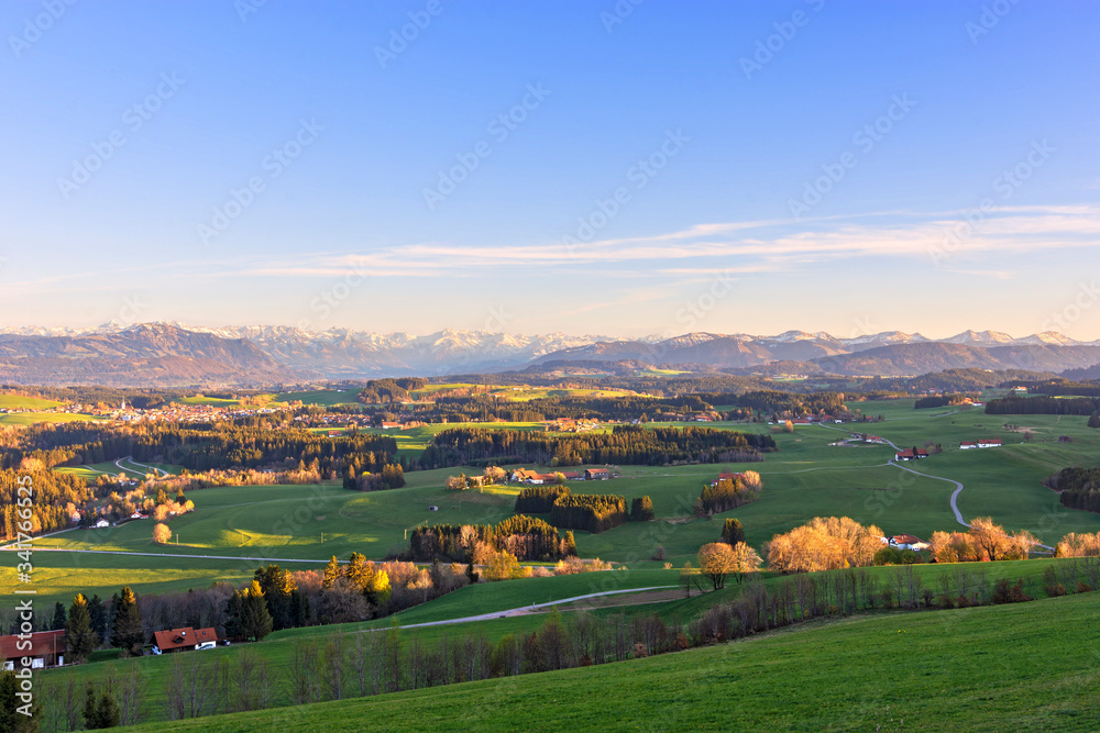 Colorful sunset in the Allgäu region. Snow-covered mountains in the background. Bavaria, Germany
