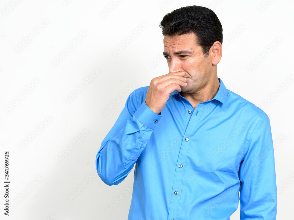 Portrait of stressed mature businessman looking disgusted and covering nose Portrait of stressed mature businessman looking disgusted and covering nose