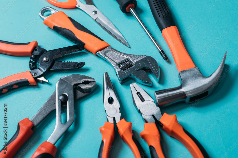 group bunch of tools with orange handles on a blue background close group bunch of tools with orange handles on a blue background close