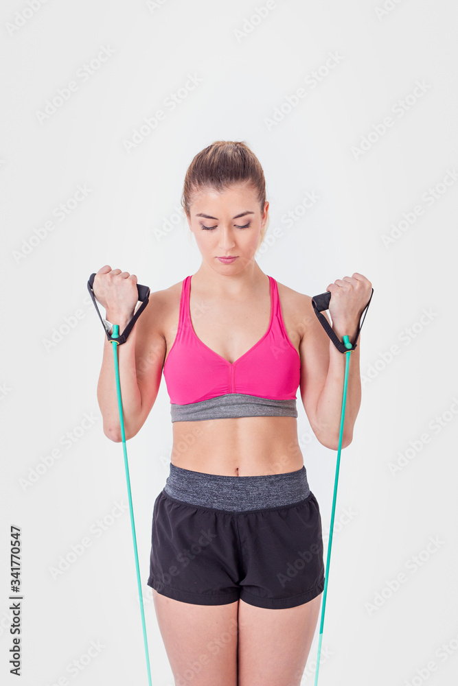 Young woman working out with rubber bands Young woman working out with rubber bands