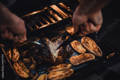 Man chef check roasted pork belly on baking tray cooked in oven. Traditional country cuisine. Baked fat meat. Cooked meal. Home made handmade food. Rustic style. Gastronomy concept. Appetizing dinner