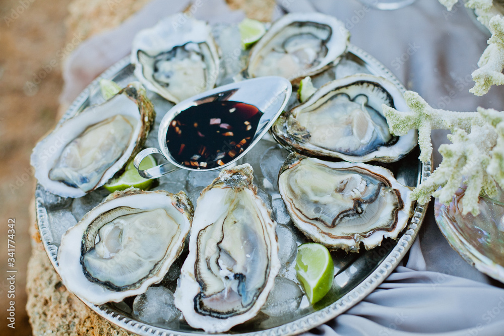 Oysters on the big beautiful silver plate Oysters on the big beautiful silver plate