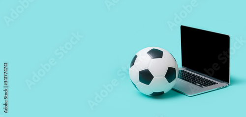 Laptop With Soccer Football Ball On Blue color background. Workout online concept