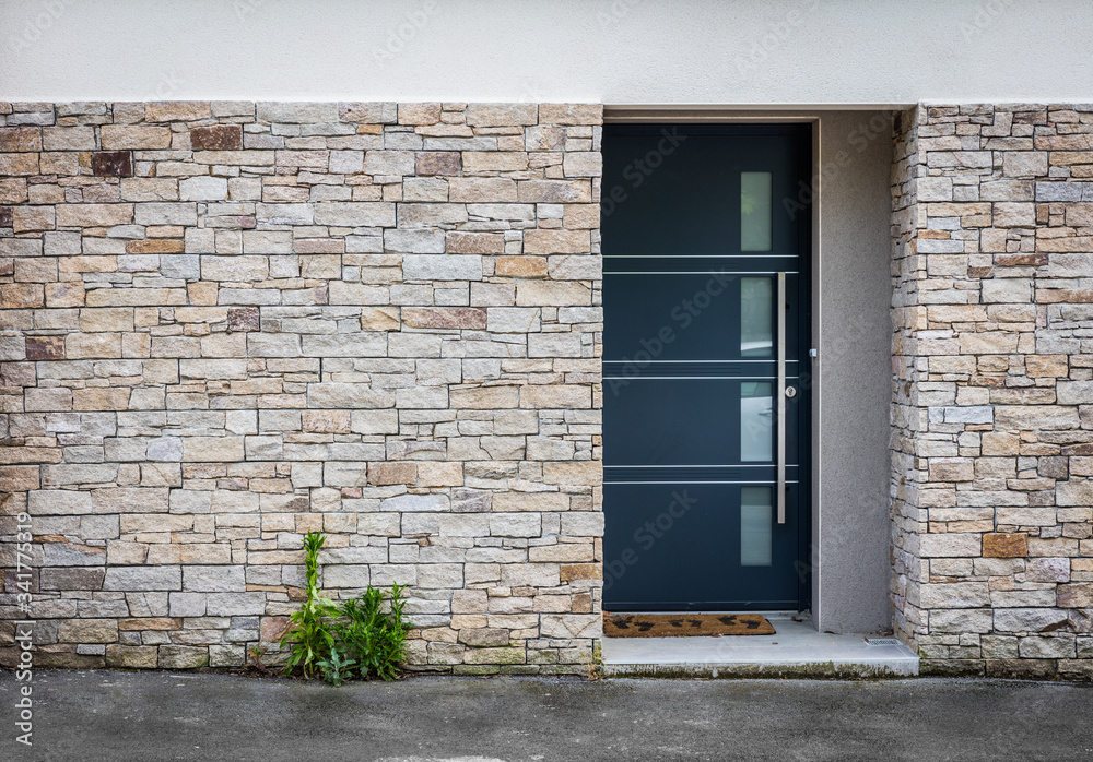Modern entry house with stone wall