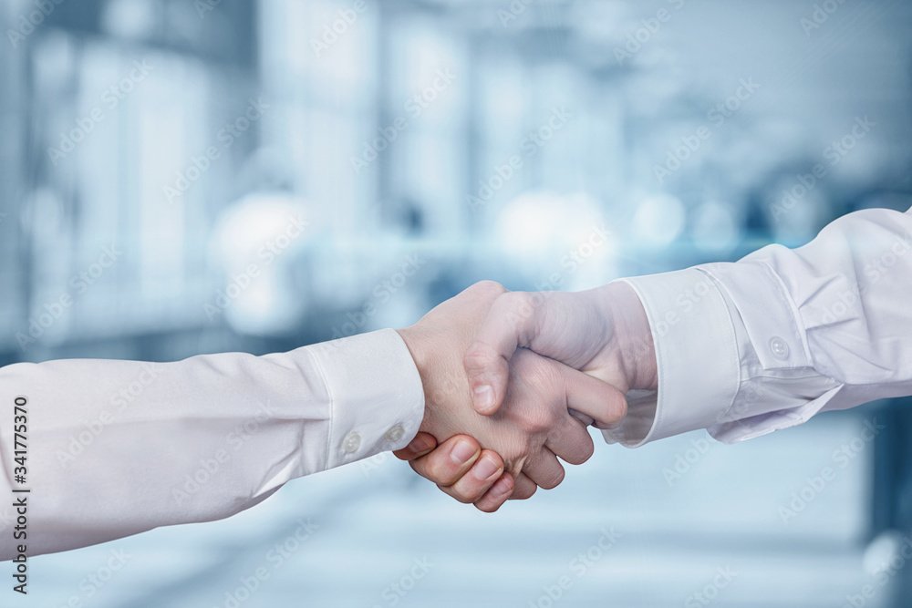 Handshake of doctors on a blurred background. Handshake of doctors on a blurred background.