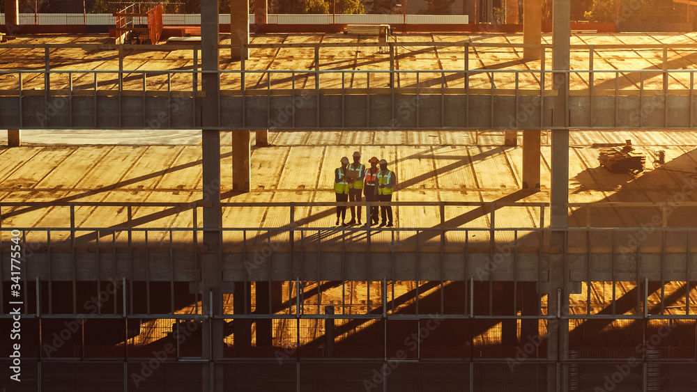 Aerial View: Diverse Team of Specialists Inspect Commercial, Industrial Building / Skyscraper Formwork Construction Site. Real Estate Project Lead by Civil Engineer, Investor, Architect and Worker 