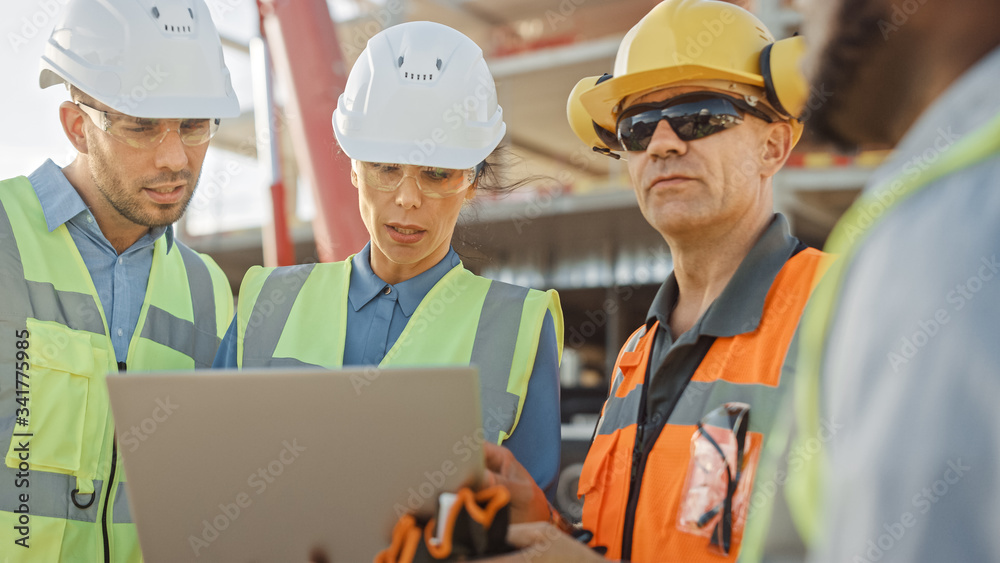 Diverse Team of Specialists Use Laptop Computer on Construction Site. Real Estate Building Project with Machinery: Civil Engineer, Investor, Businesswoman and Builder Discussing Blueprint Plan Diverse Team of Specialists Use Laptop Computer on Construction Site. Real Estate Building Project with Machinery: Civil Engineer, Investor, Businesswoman and Builder Discussing Blueprint Plan