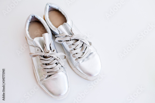 top view metallic silver shoes on white background