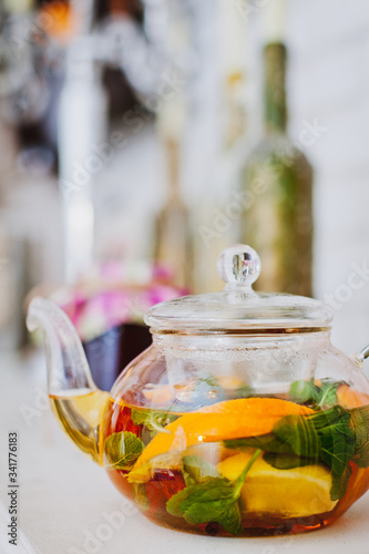 glass teapot with fruit and citrus tea