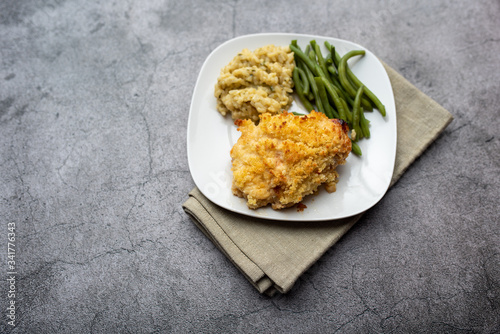 Parmesan crusted chicken breast with green beans and risotto 