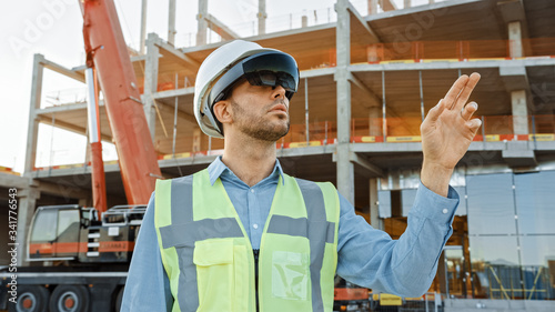 Konstfotografi Futuristic Architectural Engineer Wearing Augmented Reality Headset and Using Gestures to Control Commercial Building Construction Site