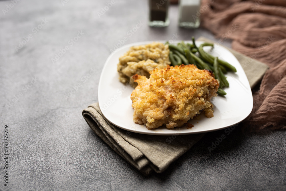 Parmesan crusted chicken breast with green beans and risotto 