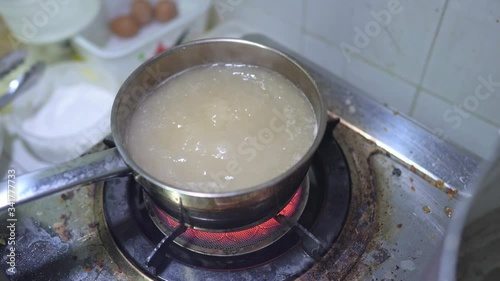 Close up scene of cooking Bak Kut Teh by boiling garlic in the herb ribs stock soup, food processing, Malaysian and Singaporean Traditional dish, cooking step, food preparation, one of the famous dish photo