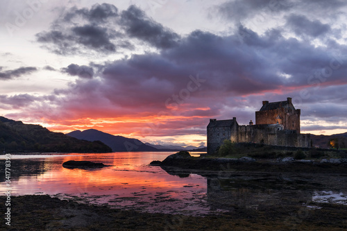 Eilean Donan Castle with colourful sunset in background - Dornie  Scotland - United Kingdom.