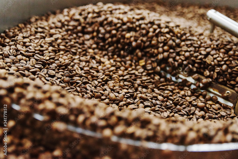 Coffee brown roasted beans. The roasting process in the roaster Coffee brown roasted beans. The roasting process in the roaster