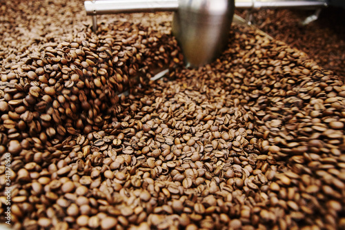 Coffee brown roasted beans. The roasting process in the roaster