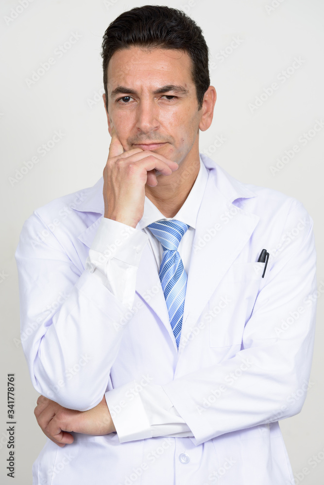 Portrait of mature handsome man doctor thinking Portrait of mature handsome man doctor thinking