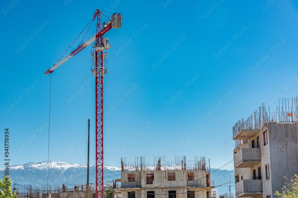 Tower crane on a construction site in the mountains mountains