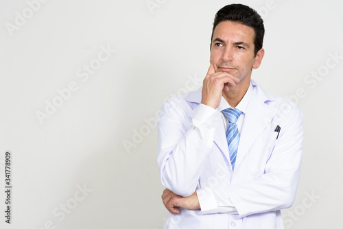 Portrait of mature handsome man doctor thinking