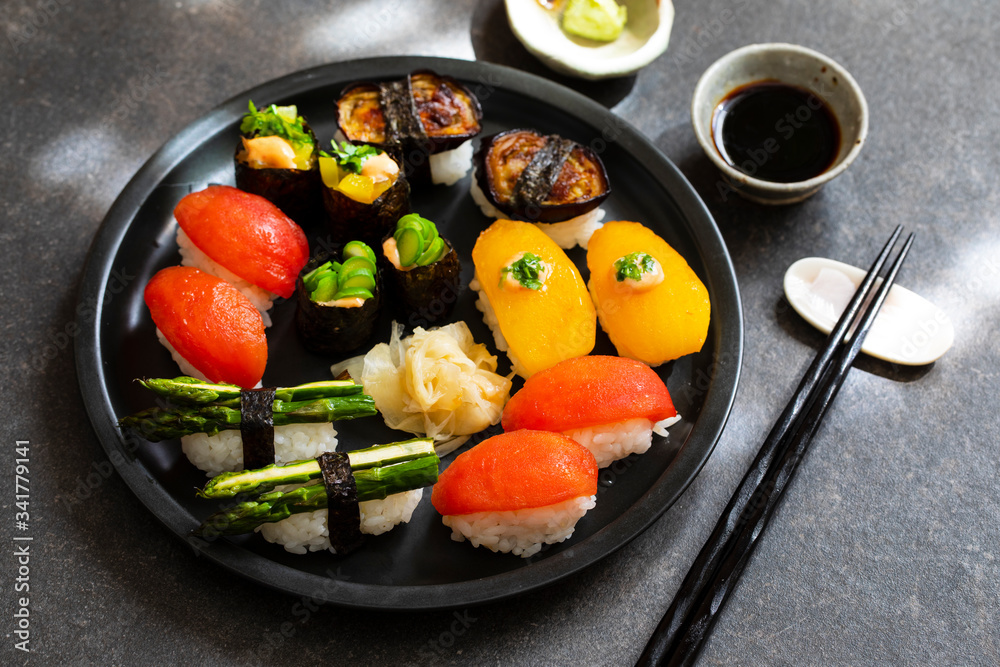 Selection of vegan sushi with tomatoes, aubergine, asparagus and pepper Selection of vegan sushi with tomatoes, aubergine, asparagus and pepper