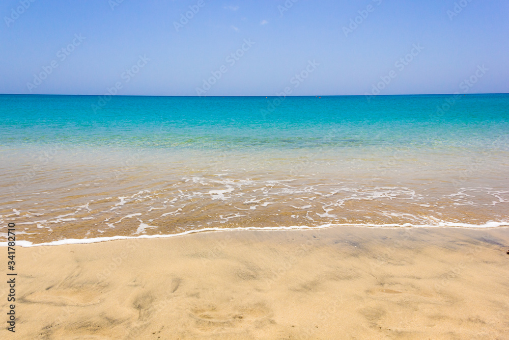 Calm sea on empty beach with turquoise water. Nobody on colorful seashore of tropical island. Idyllic summer holidays, paradise destintation concepts