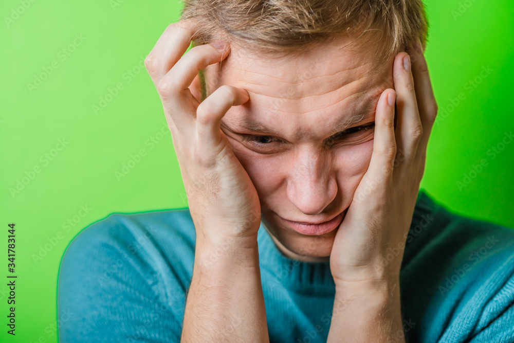 Fototapeta premium A young man having a headache