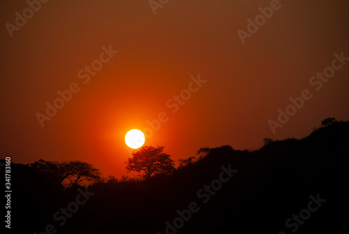 Setting the Sun at dusk from Guatemala City, silhouetted by mountains and trees, peaceful dusk in the middle of the Covid 19 pandemic Central America.