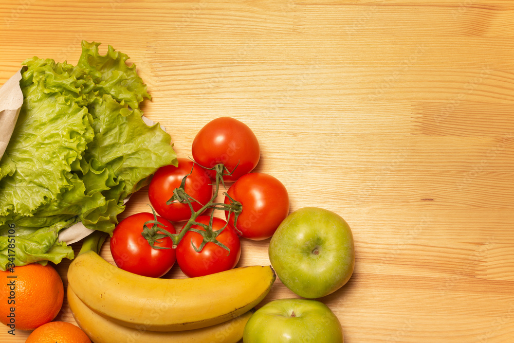 Food delivery service. Healthy food on wooden table. Buy online during quarantine. Tomatos, apples, bananas, oranges, salad. High quality photo. Stay home, be safe. Food delivery service. Healthy food on wooden table. Buy online during quarantine. Tomatos, apples, bananas, oranges, salad. High quality photo. Stay home, be safe.