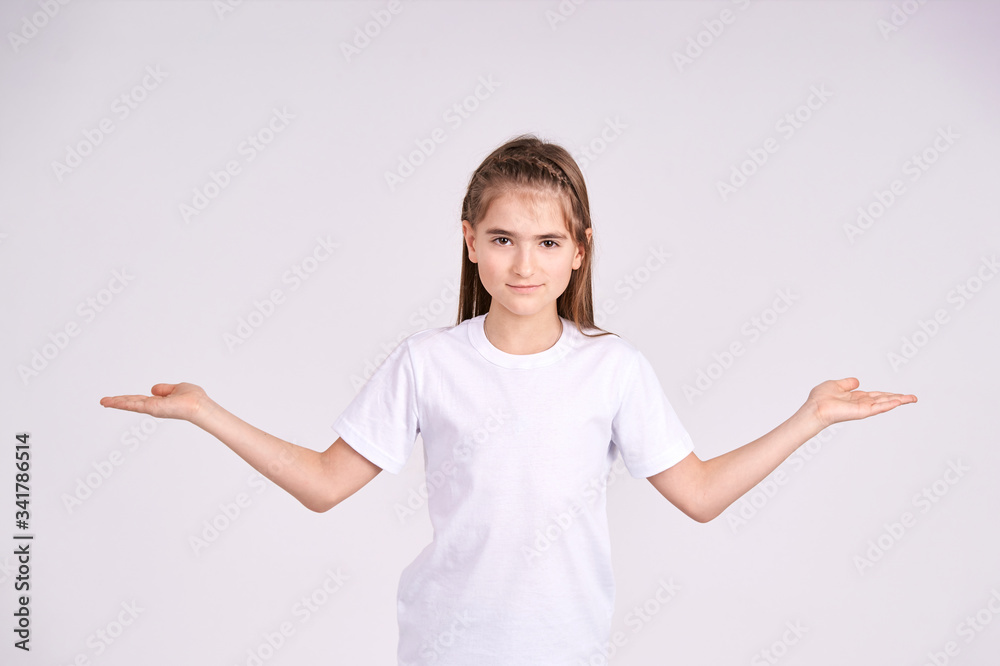 Young pretty girl gesturing. People choice options. Little woman make decision. Good food vs fastfood. Studio female portrait. Grey background with copy space. Young pretty girl gesturing. People choice options. Little woman make decision. Good food vs fastfood. Studio female portrait. Grey background with copy space.