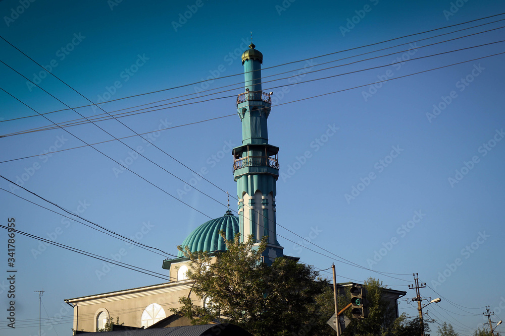 Minaret view between wires, Osh city suburbs, Kyrgyzia