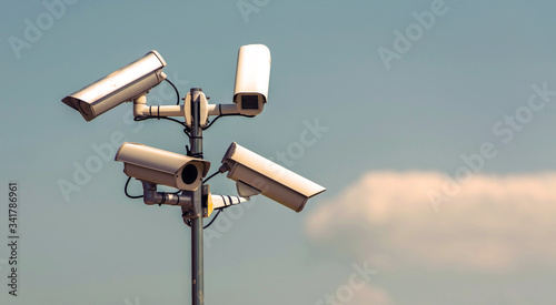 Security cameras, CCTV, video surveillance against blue sky.