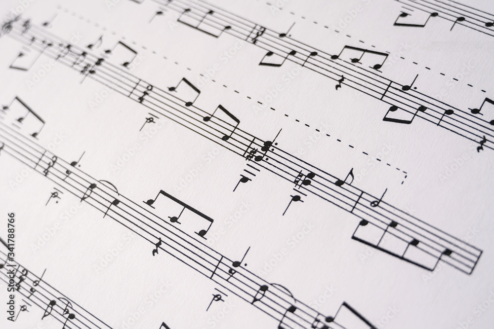 Close up musical notes printed on the paper. Selective focus. Musical notation Close up musical notes printed on the paper. Selective focus. Musical notation