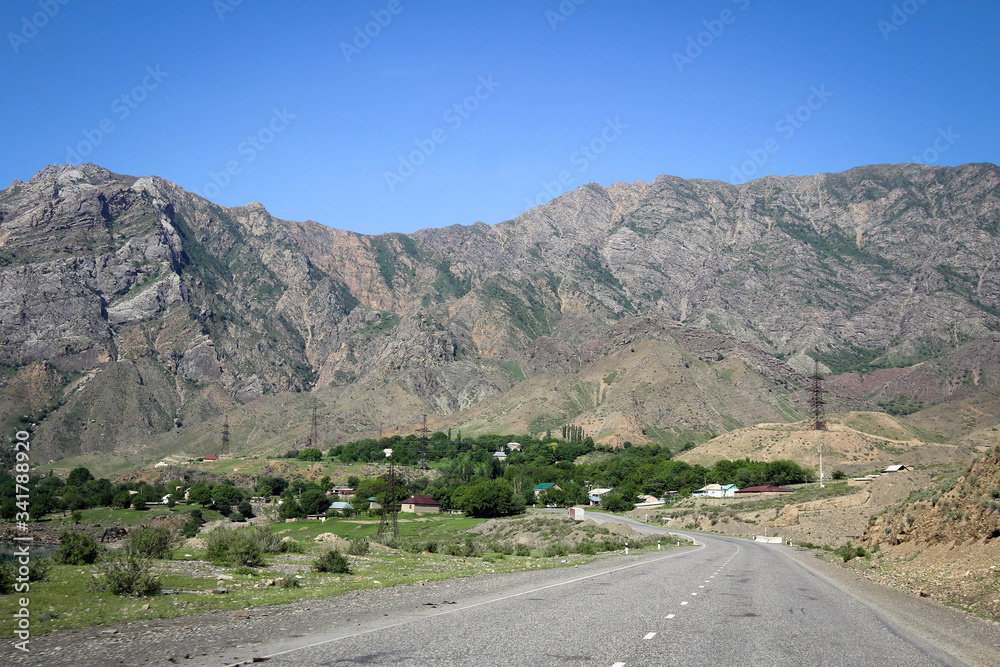 Scenic road view of green valleys and Tian Shan range, Central Kyrgyzia