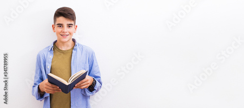 Fotografija young teenager student with book isolated on white background