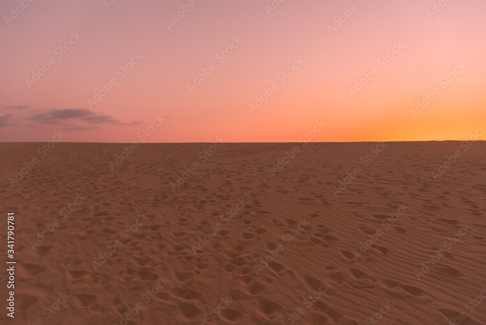 colorful sunset over desert sand dunes