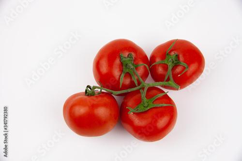 Isolated red, fresh and juicy tomatoes on a white background. Vegetables for fresh salad. © iKagadiy