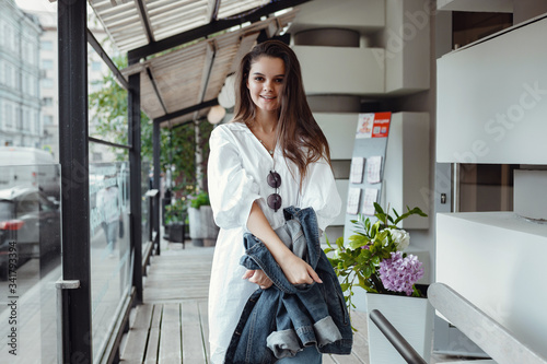 lifestyle fashion portrait of young stylish hipster woman in city