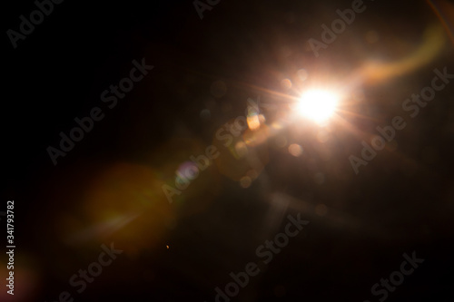Abstract Natural Sun flare on the black background.