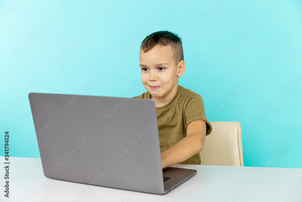 Online home learning concept. Boy sitting with computer and doing homework Online home learning concept. Boy sitting with computer and doing homework
