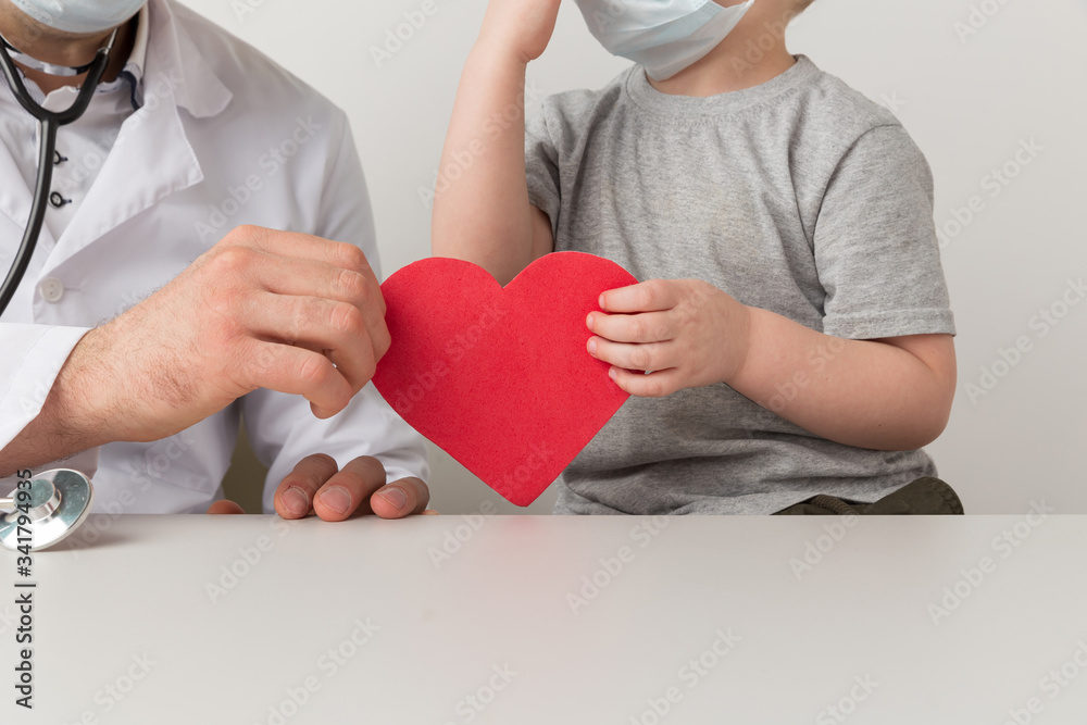 Doctor with child holding heart. Prevention of disease Doctor with child holding heart. Prevention of disease