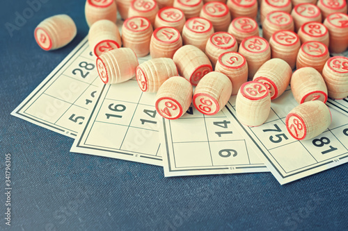 Wooden kegs and cards for a game in a lotto. on green background. 