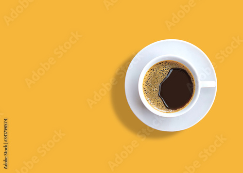 cup of espresso coffee on yellow background.