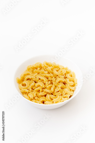 Delicious pasta or penne noodles, isolated on white background. Top view scene, healthy eating or healthy lifestyle. Penne pasta or macaroni in a white bowl, italian cuisine.