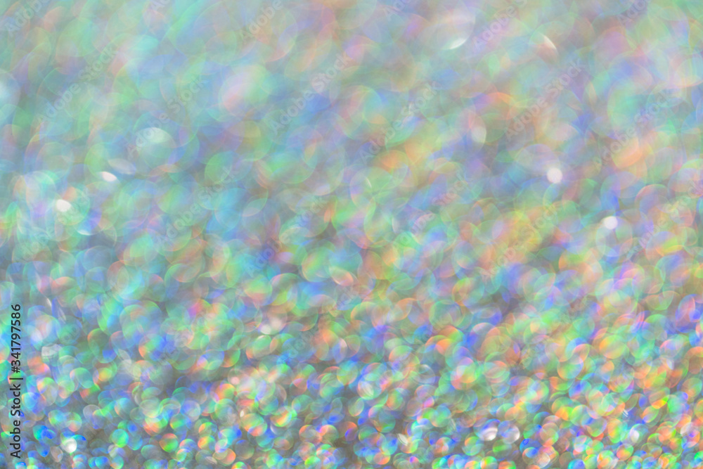 Abstract shiny colored sparkles background with blur bokeh.